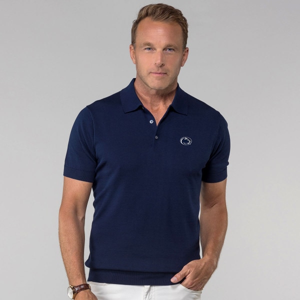 model wearing navy cotton/silk polo shirt with embroidered Penn State Athletic Logo on left chest